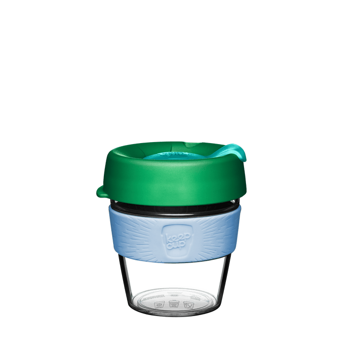 Reusable glass coffee cup with a green lid on a transparent background
