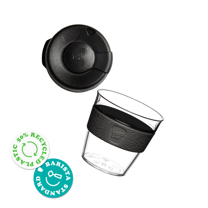 KeepCup Original Clear S 8oz shown with the lid separated from the clear plastic reusable cup featuring a silicone band with KeepCup branding. Badges indicate 50% recycled plastic and Barista Standard certification.