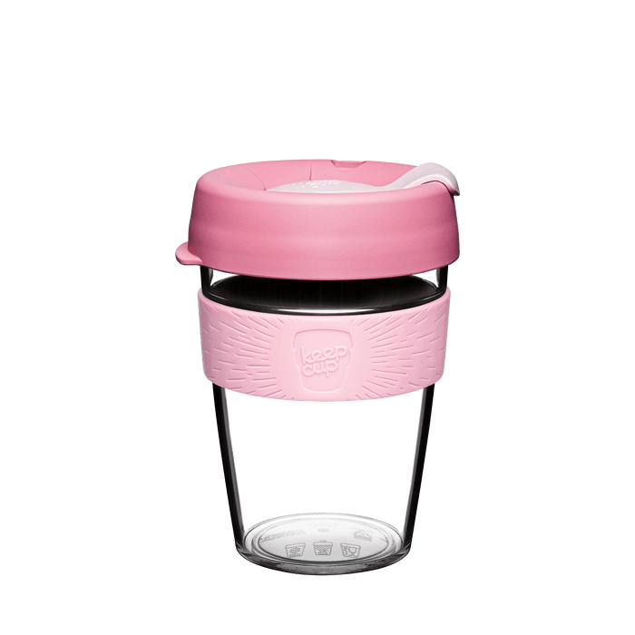 KeepCup Tritan plastic reusable coffee cup with pink silicone sleeve and lid on a white background