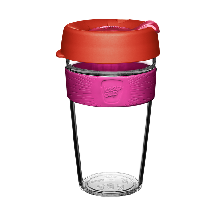 KeepCup Original Clear L 16oz in Daybreak colour, featuring a clear plastic cup body, bright pink silicone band with embossed logo, and coral-red lid with sipper closure, shown against a white background.