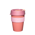 KeepCup Original M 12oz in Peaches, featuring a coral-coloured reusable cup with a dusty pink lid, peach-toned sipper plug, and light pink silicone band with embossed KeepCup logo, shown against a white background.