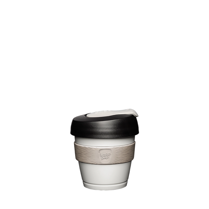 KeepCup Original XXS 4oz in Arctic colour, featuring a white cup body with beige silicone band and black lid with cream-coloured plug, shown against a plain white background.