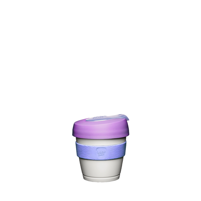 KeepCup Original XXS 4oz in Lilac, featuring a white cup body, lavender silicone band with embossed logo, and purple lid with clear sip-through plug, shown against a plain white background.