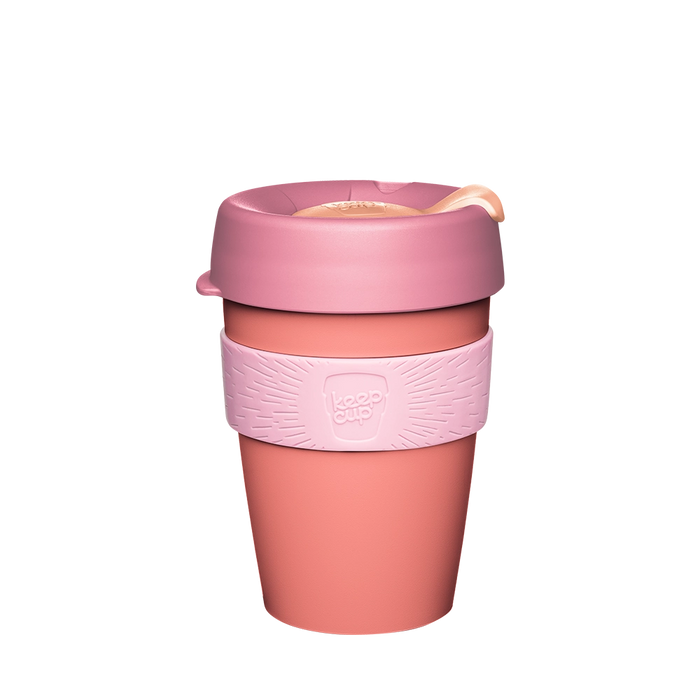 KeepCup Original M 12oz in Peaches, featuring a coral-coloured reusable cup with a dusty pink lid, peach-toned sipper plug, and light pink silicone band with embossed KeepCup logo, shown against a white background.