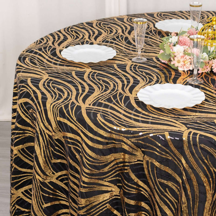 Elegant black and gold wave-patterned tablecloth on a round table.