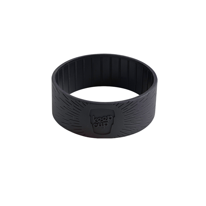 Black silicone band for KeepCup in size S/M/L, shown at a slight angle against a white background, featuring a ribbed interior texture and embossed KeepCup logo with radiating line pattern on the outer surface.