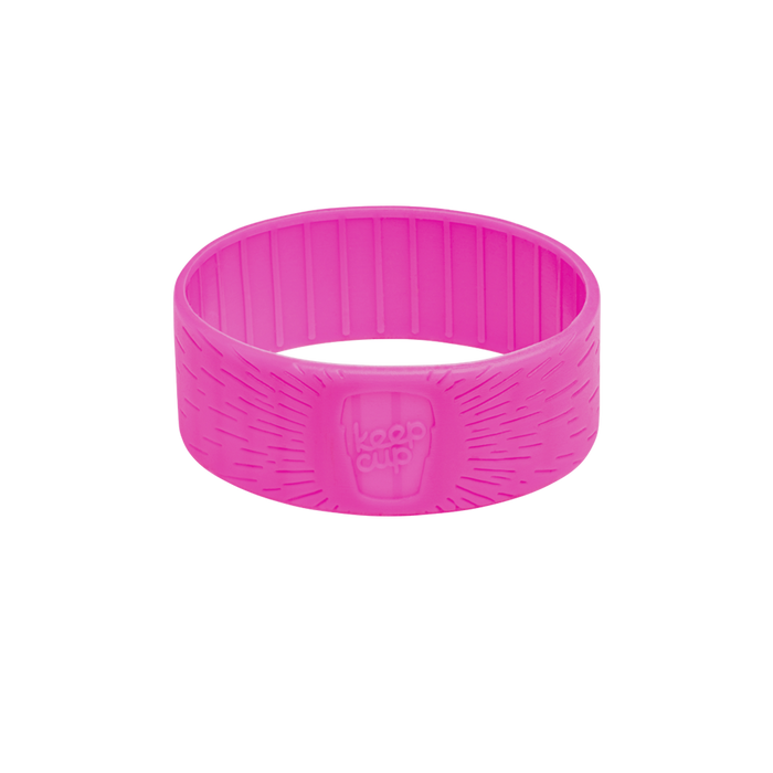 Flamingo pink silicone band for KeepCup in size S/M/L, shown at a slight angle on a white background, featuring textured ridges on the interior and the embossed KeepCup logo on the exterior with radiating line detail.