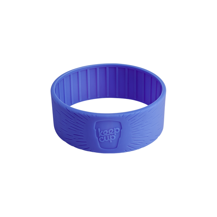 Silicone Band in Indigo, shown at a three-quarter angle against a white background, displaying the embossed KeepCup logo and radiating line texture on the exterior, with vertical ribbing visible on the inner surface.