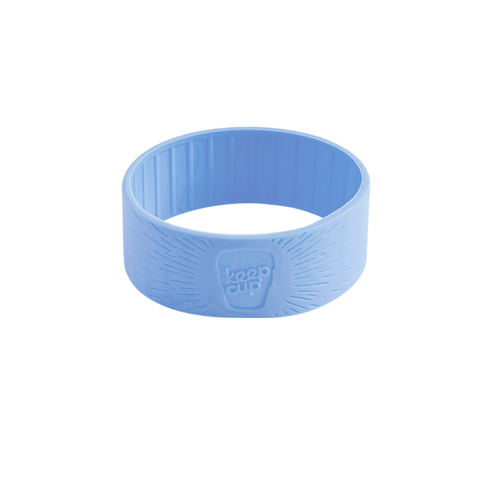 Light blue silicone band in Orchid colour, shown at a slight angle on a white background, featuring the embossed KeepCup logo and textured grip pattern on the exterior.