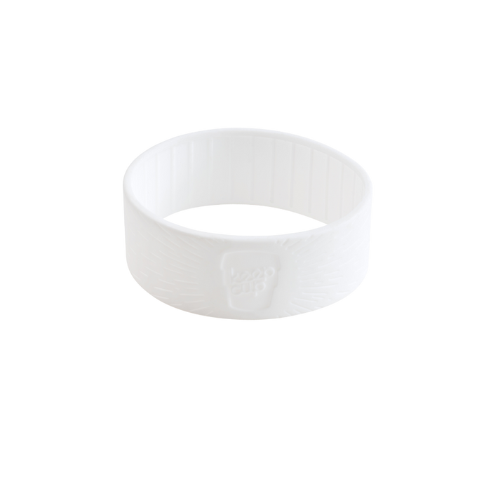 White silicone band for KeepCup in S/M/L size, shown at a three-quarter angle against a plain white background, featuring the embossed KeepCup logo and textured ribbed surface for grip.