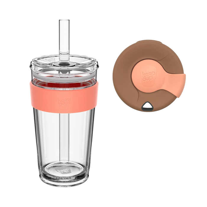 KeepCup Sip and Chill Longplay in Frappe, a clear double-walled reusable cup with coral silicone band and straw, shown alongside a brown and coral replacement lid with sliding closure.