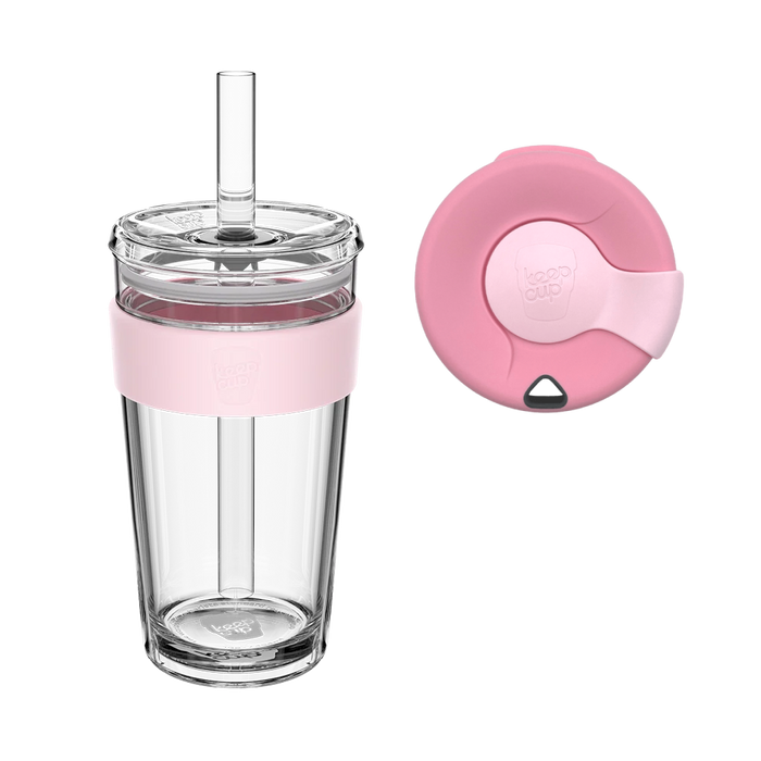 KeepCup Sip and Chill Longplay in Pashmak, a clear double-walled tumbler with soft pink silicone band and reusable straw, shown alongside a top-down view of the matching pink lid with drinking spout and straw opening.