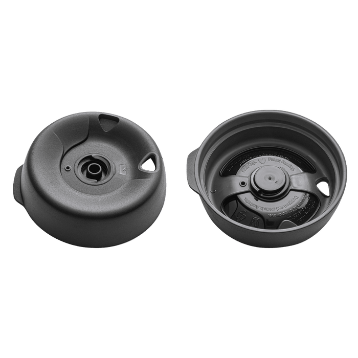 KeepCup Splashproof Lid Base in Black for Brew XS, shown from two angles: the top view displaying the central spout opening and side grips, and the underside view revealing the internal valve mechanism and patent markings.