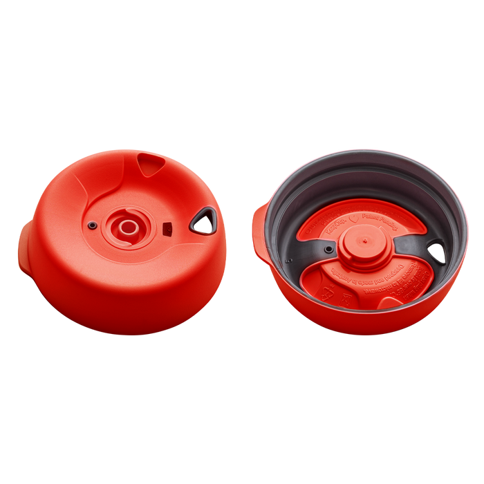KeepCup Splashproof Lid Base in Warm Red for Brew XS, shown from two angles: the top view displaying the circular lid with central drinking spout and side openings, and the underside view revealing the red inner mechanism fitted within the grey outer ring.