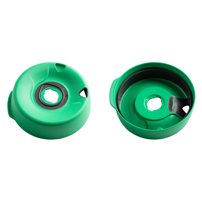 Splashproof Lid Base in Emerald shown from two angles: the top view displaying the central drinking hole with grey silicone seal and triangular vent, and the underside view revealing the inner construction and moulded text details.