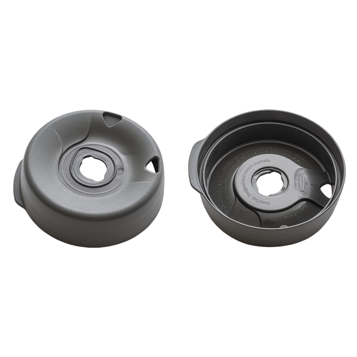 Splashproof Lid Base in Soft Charcoal shown from two angles: the top view displaying the central drinking hole and side ventilation slots, and the interior view revealing the KeepCup branding and text "Designed and made in Australia.