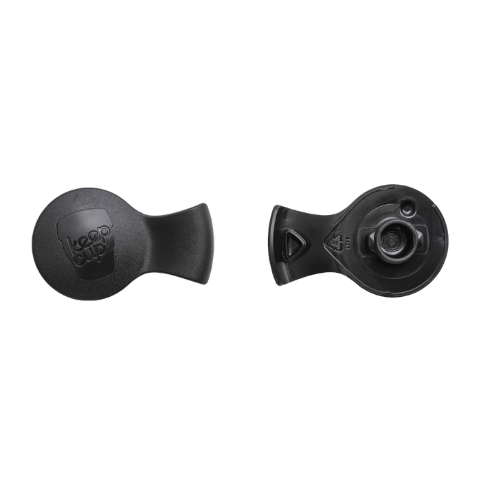 Splashproof Plug in Black shown from two angles: the top view displays the embossed KeepCup logo, while the underside reveals the circular plug mechanism and recycling symbol.