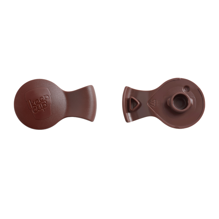 Top and bottom views of the KeepCup Splashproof Plug in Han Solo colour, showing the branded outer surface with embossed KeepCup logo and the underside with triangular vent holes and central stopper mechanism.