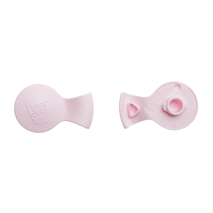 KeepCup Splashproof Plug in Pashmak Pink shown from two angles: the top view displaying the embossed KeepCup logo, and the underside revealing the plug mechanism and LDPE recycling symbol.