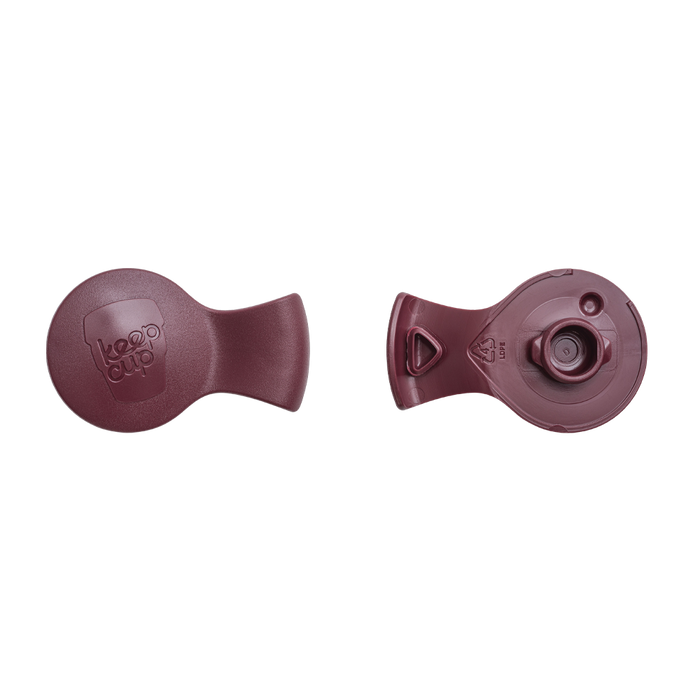 Top and bottom view of the KeepCup Splashproof Plug in Plum, showing the smooth outer surface with embossed KeepCup logo and the underside with valve mechanism and LDPE recycling symbol.