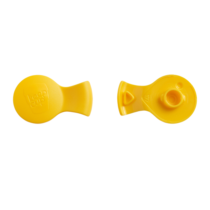 Two views of the KeepCup Splashproof Plug in Yellow Bird, showing the smooth top surface with embossed KeepCup logo on the left and the underside with the plug mechanism and fitting details on the right, photographed against a white background.