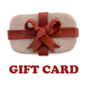 Seattle Pottery Supply gift card: pale clay slab wrapped in a red clay ribbon and bow stamped SPS