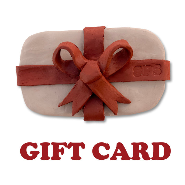 Seattle Pottery Supply gift card: pale clay slab wrapped in a red clay ribbon and bow stamped SPS